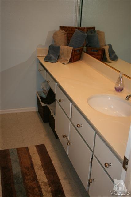 1706 Sinaloa Road, Unit 208 Simi Valley, CA 93065 - Photo 12 of 21 a bedroom with a bed and a potted plant on the dresser