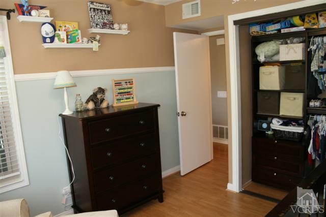 1706 Sinaloa Road, Unit 208 Simi Valley, CA 93065 - Photo 14 of 21 a kitchen with a refrigerator and a stove