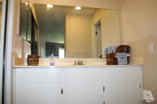 1706 Sinaloa Road, Unit 208 Simi Valley, CA 93065 - Photo 17 of 21 a bathroom with a sink and a mirror