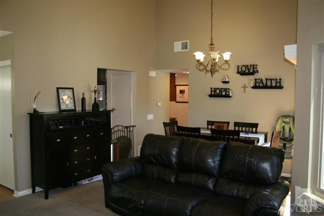 1706 Sinaloa Road, Unit 208 Simi Valley, CA 93065 - Photo 4 of 21 a living room with furniture and a chandelier
