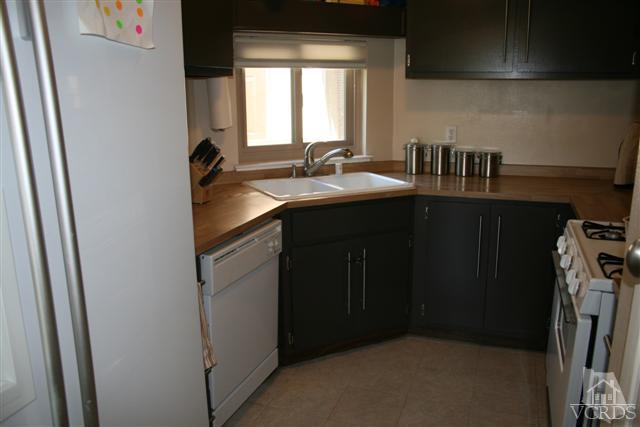 1706 Sinaloa Road, Unit 208 Simi Valley, CA 93065 - Photo 7 of 21 a kitchen with a sink and a refrigerator
