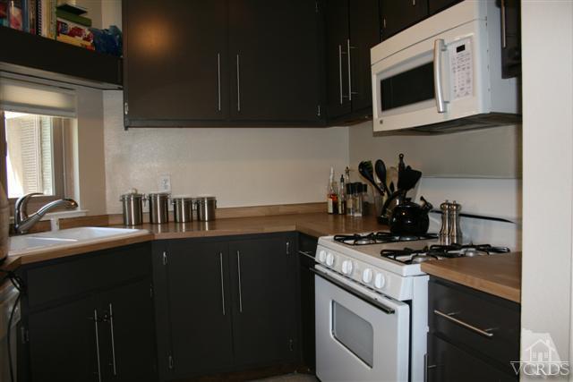 1706 Sinaloa Road, Unit 208 Simi Valley, CA 93065 - Photo 8 of 21 a kitchen with a sink stove and microwave