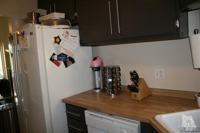 1706 Sinaloa Road, Unit 208 Simi Valley, CA 93065 - Photo 10 of 21 a kitchen with a refrigerator and a sink