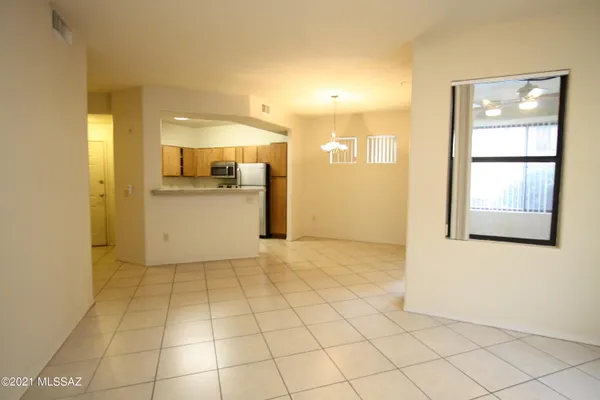 a view of a kitchen with a sink and a refrigerator