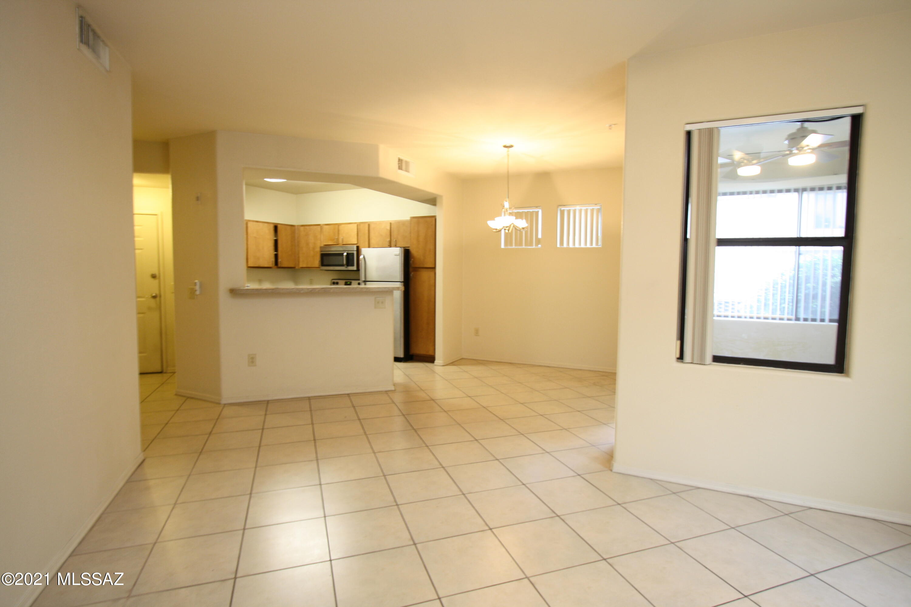 2550 East River Road, Unit 5104 Tucson, AZ 85718 - Photo 1 of 14 a view of a kitchen with a sink and a refrigerator