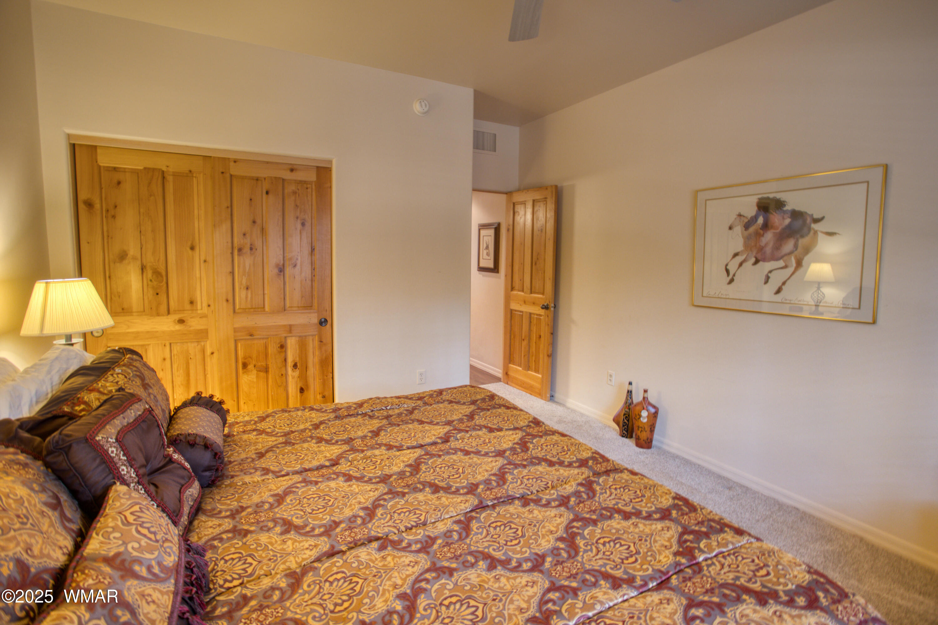 2566 Village Loop, Unit 19 Pinetop, AZ 85935 - Photo 15 of 30 a bedroom with a bed and a painting on the wall