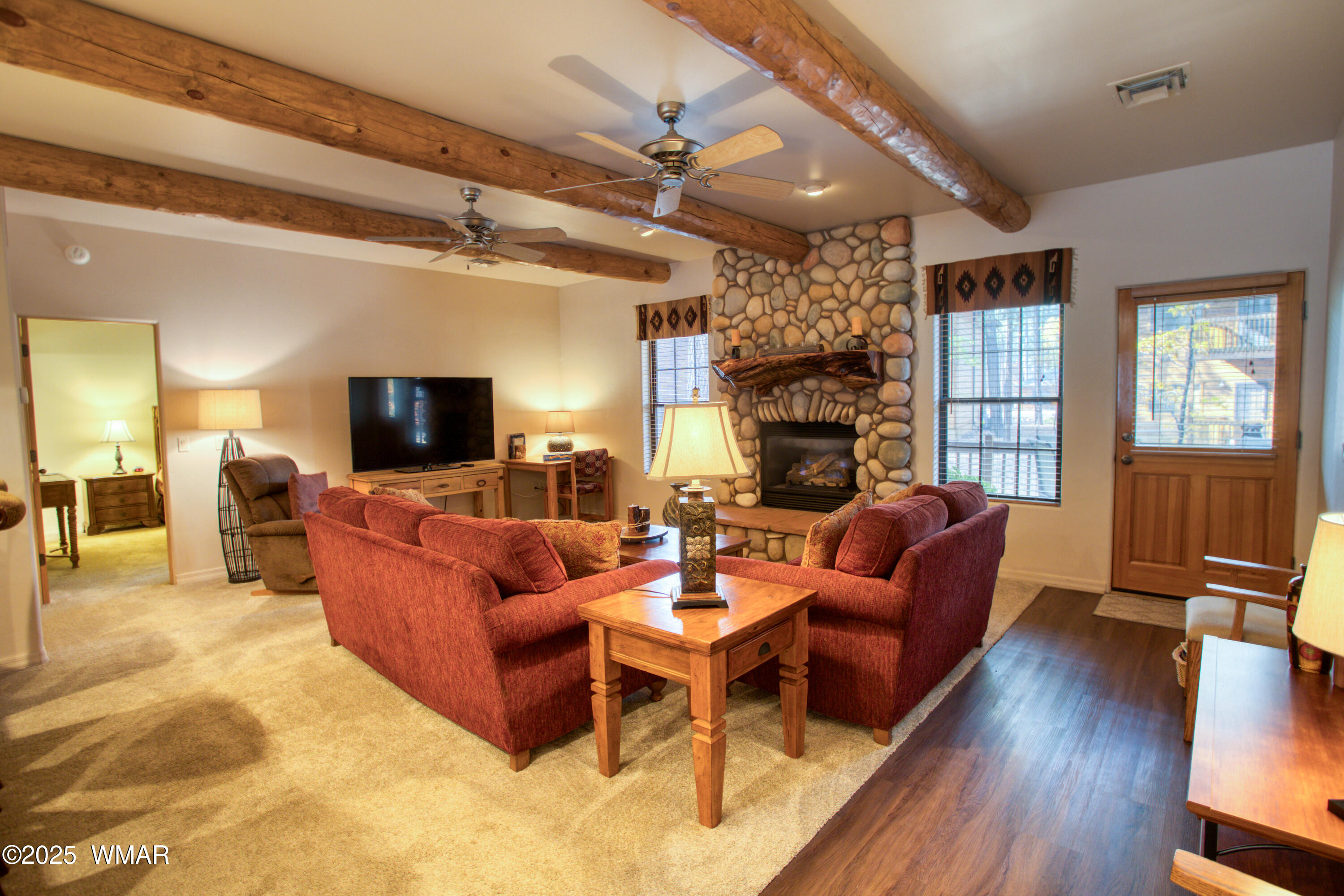 2566 Village Loop, Unit 19 Pinetop, AZ 85935 - Photo 3 of 30 a living room with fireplace furniture and a flat screen tv