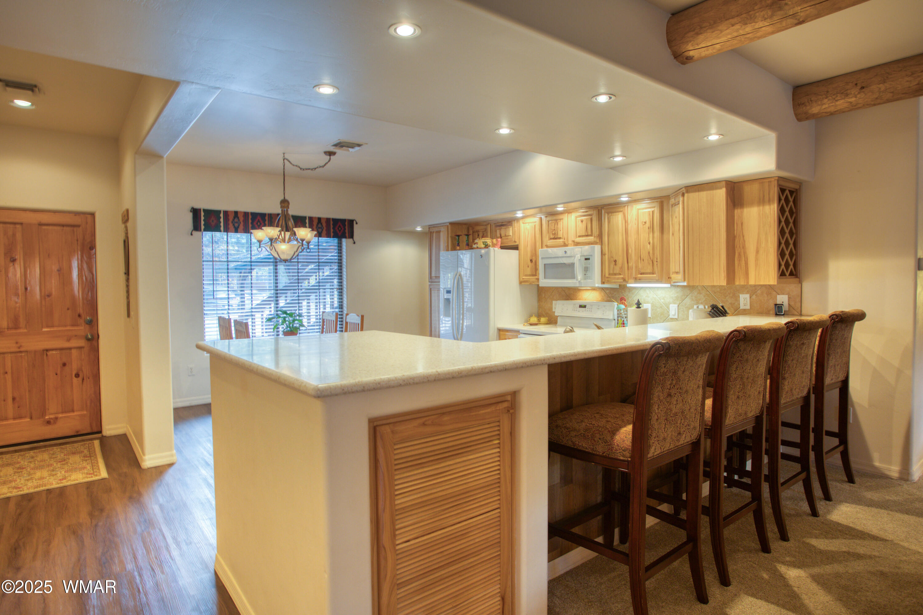 2566 Village Loop, Unit 19 Pinetop, AZ 85935 - Photo 8 of 30 a kitchen with kitchen island granite countertop wooden floor cabinets and dining table