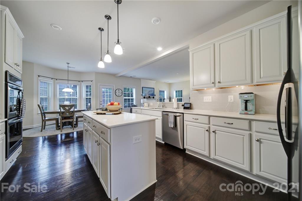 1004 Lightwood Road Waxhaw, NC 28173 - Photo 15 of 48 a kitchen with granite countertop a sink appliances and cabinets