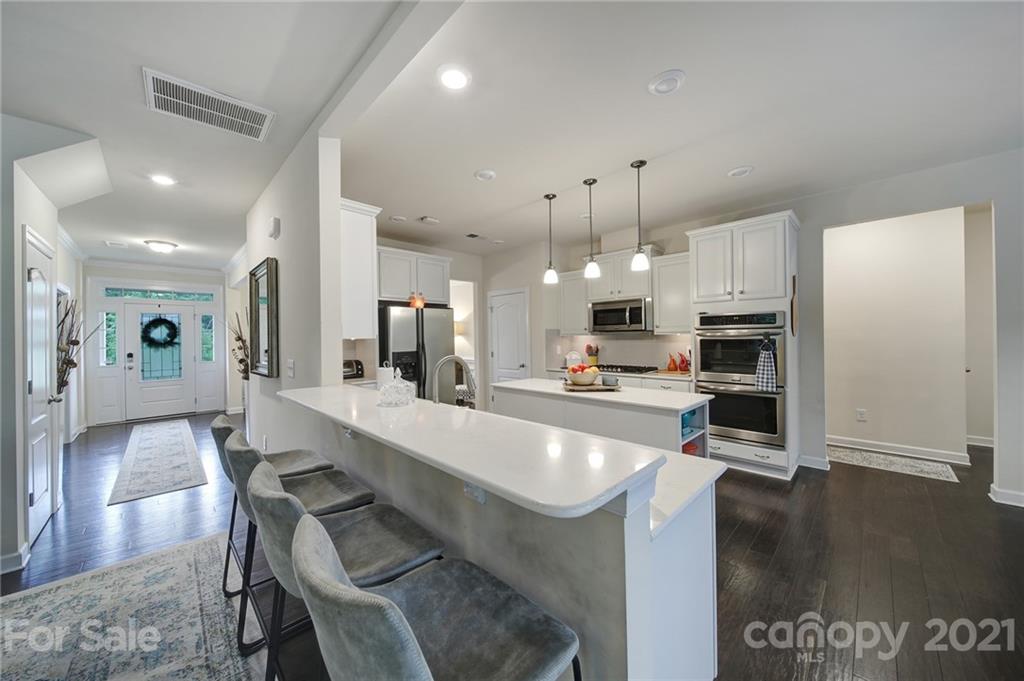 1004 Lightwood Road Waxhaw, NC 28173 - Photo 17 of 48 a large kitchen with a table and chairs