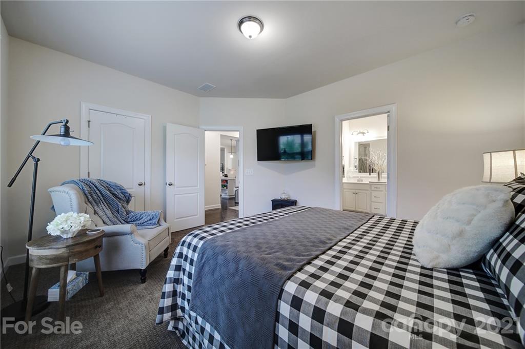 1004 Lightwood Road Waxhaw, NC 28173 - Photo 20 of 48 a bedroom with a bed and a chair