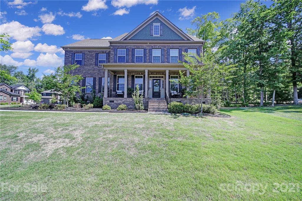 1004 Lightwood Road Waxhaw, NC 28173 - Photo 3 of 48 a front view of a house with garden