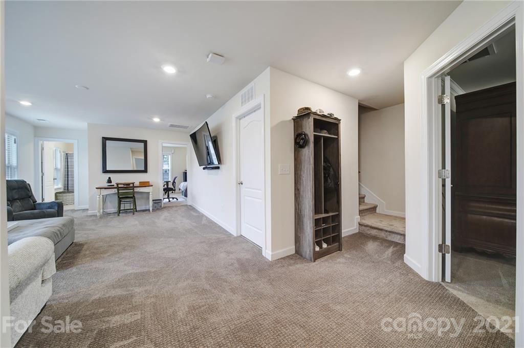 1004 Lightwood Road Waxhaw, NC 28173 - Photo 22 of 48 a view of a livingroom with furniture and a hallway