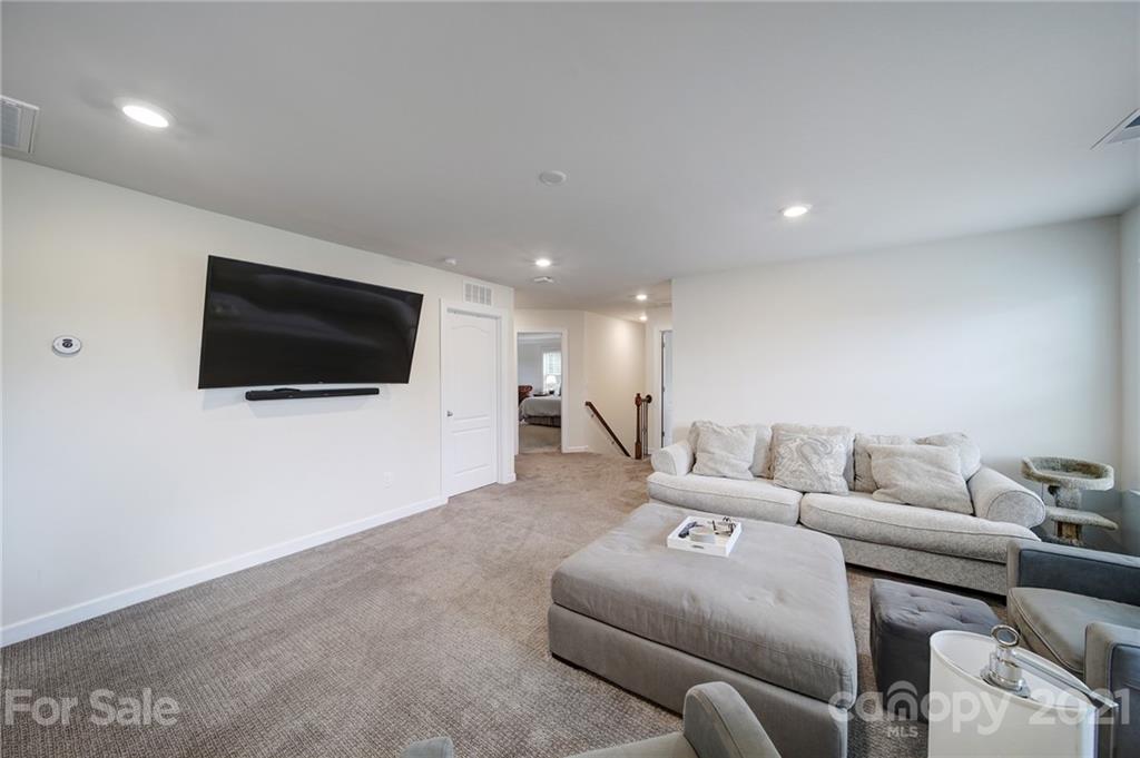 1004 Lightwood Road Waxhaw, NC 28173 - Photo 24 of 48 a living room with furniture and a flat screen tv