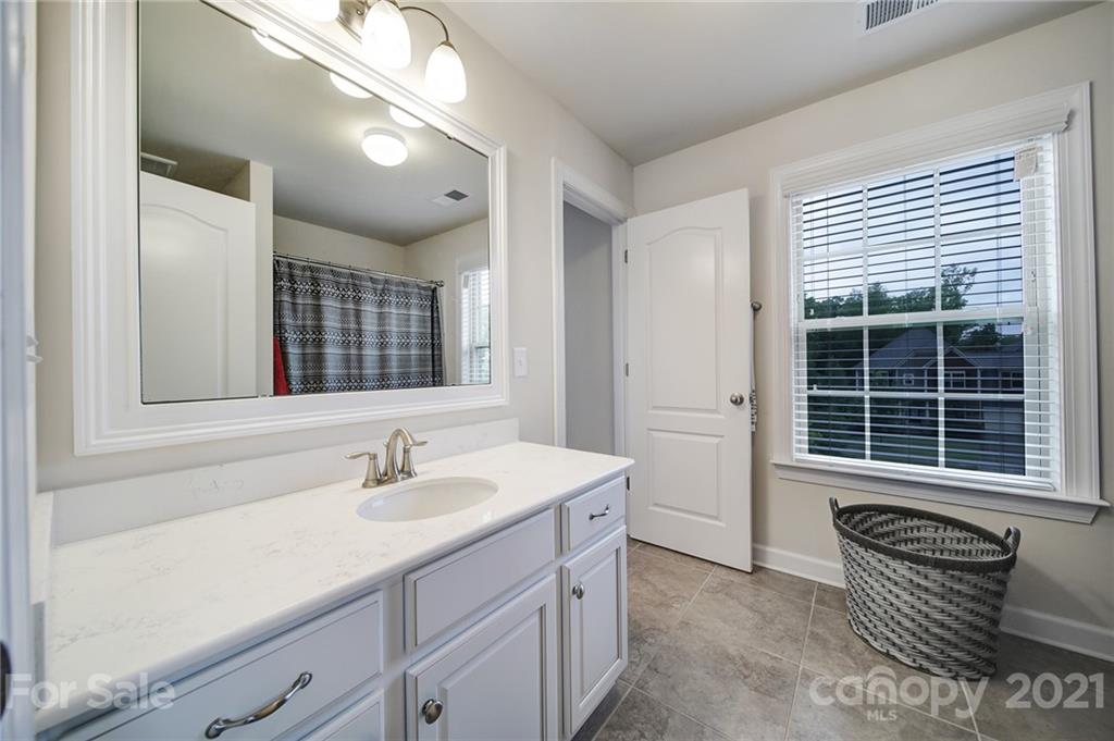 1004 Lightwood Road Waxhaw, NC 28173 - Photo 27 of 48 a bathroom with a sink and a mirror