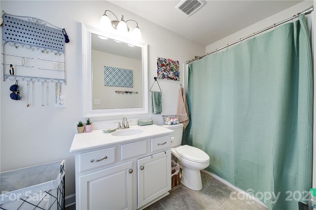 1004 Lightwood Road Waxhaw, NC 28173 - Photo 31 of 48 a bathroom with a sink a toilet and a mirror