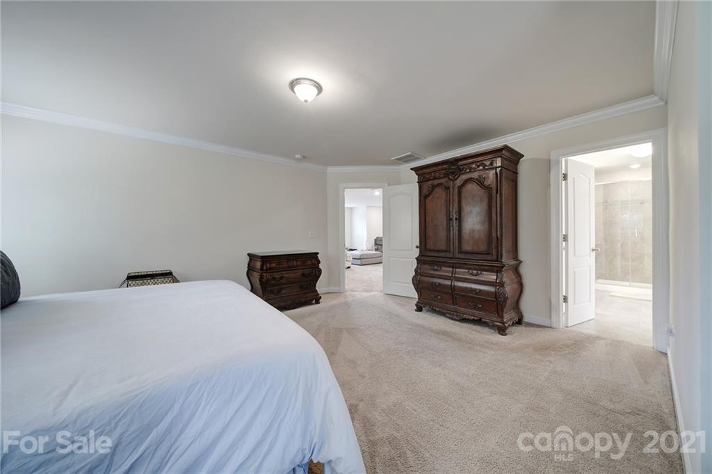 1004 Lightwood Road Waxhaw, NC 28173 - Photo 34 of 48 a spacious bedroom with a bed and a television