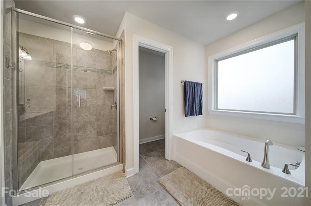1004 Lightwood Road Waxhaw, NC 28173 - Photo 36 of 48 a bathroom with a bathtub and a shower