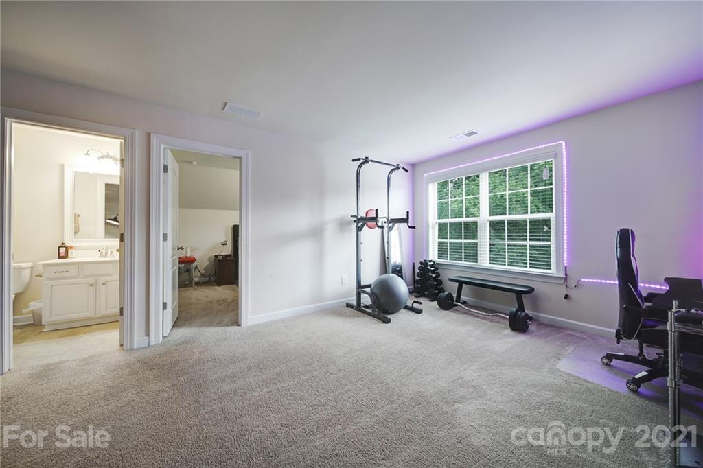 1004 Lightwood Road Waxhaw, NC 28173 - Photo 39 of 48 a view of a room with gym equipment and a large window