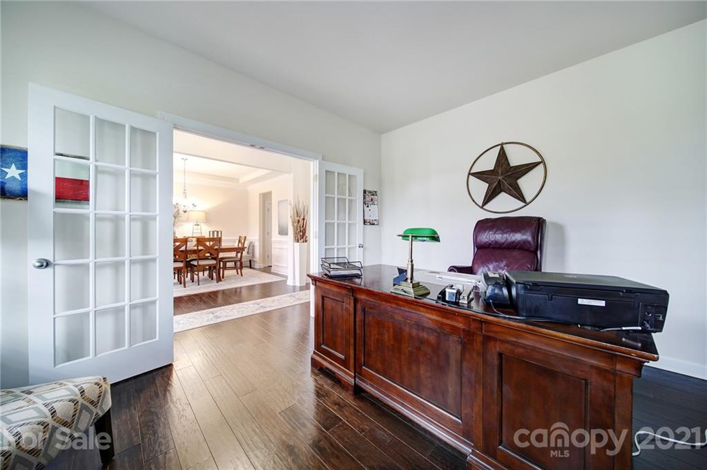 1004 Lightwood Road Waxhaw, NC 28173 - Photo 6 of 48 a living room with furniture a flat screen tv and wooden floor