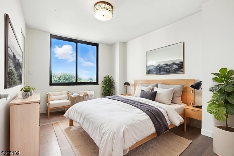 a bedroom with a large bed and a large window