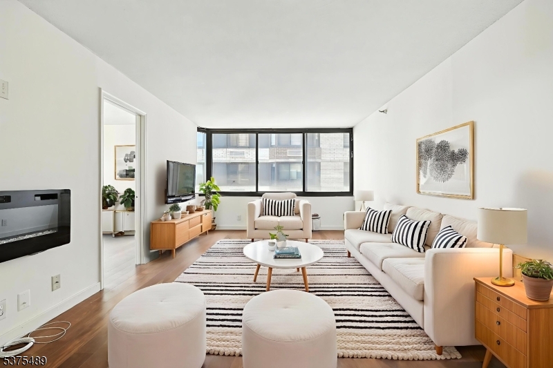 316 Prospect Avenue, Unit A Hackensack, NJ 07601 - Photo 3 of 18 a living room with furniture and a flat screen tv