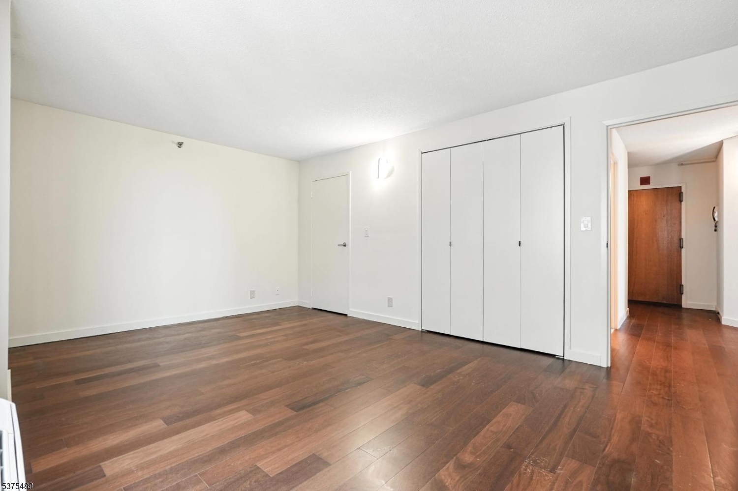 316 Prospect Avenue, Unit A Hackensack, NJ 07601 - Photo 8 of 18 a view of an empty room with wooden floor