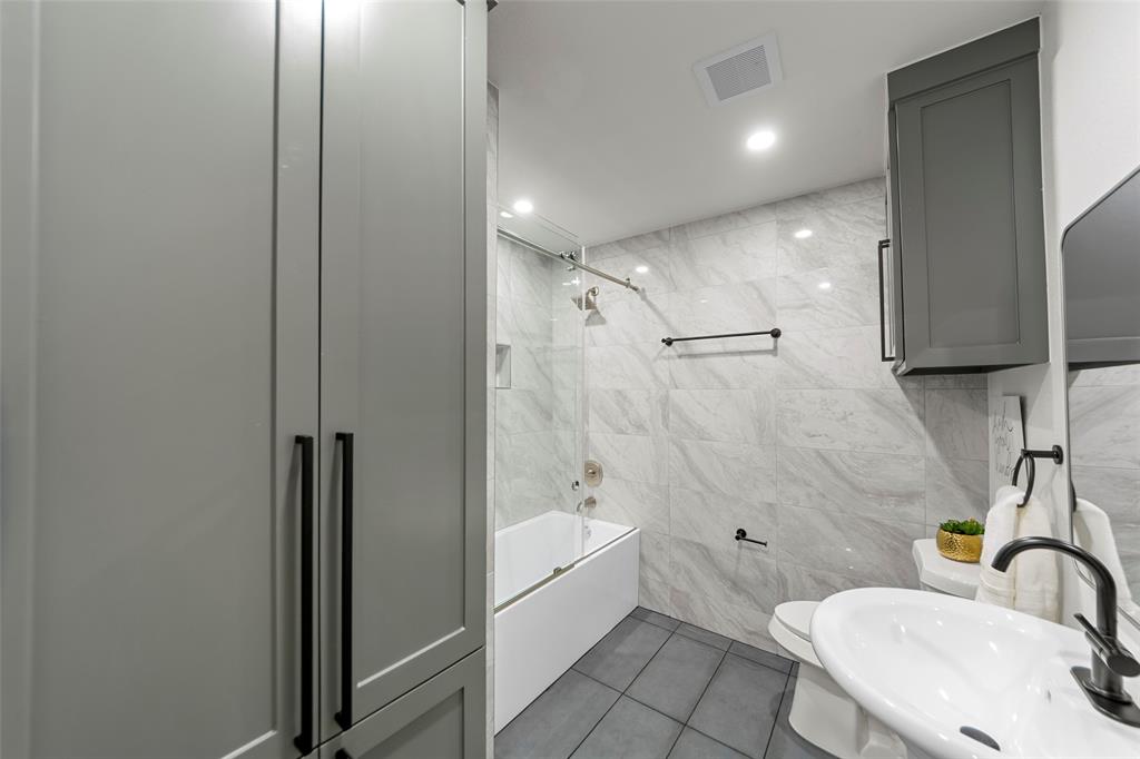 2945 Healey Drive Dallas, TX 75228 - Photo 17 of 38 a bathroom with a sink toilet and shower