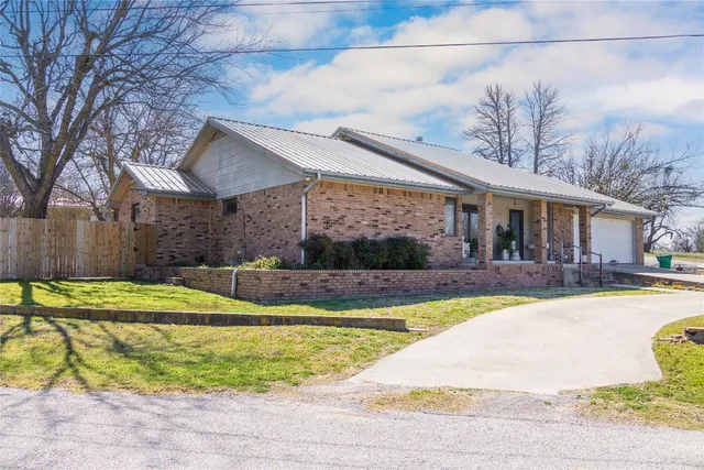 a view of a house with swimming pool and sitting area