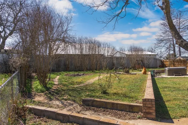 a view of a backyard with swimming pool