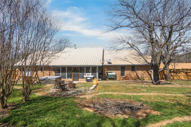 a backyard of a house with basket ball court and outdoor seating