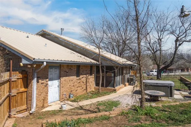 a view of a house with a yard and wooden fence