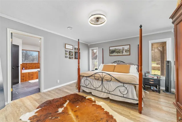 a bedroom with furniture and wooden floor