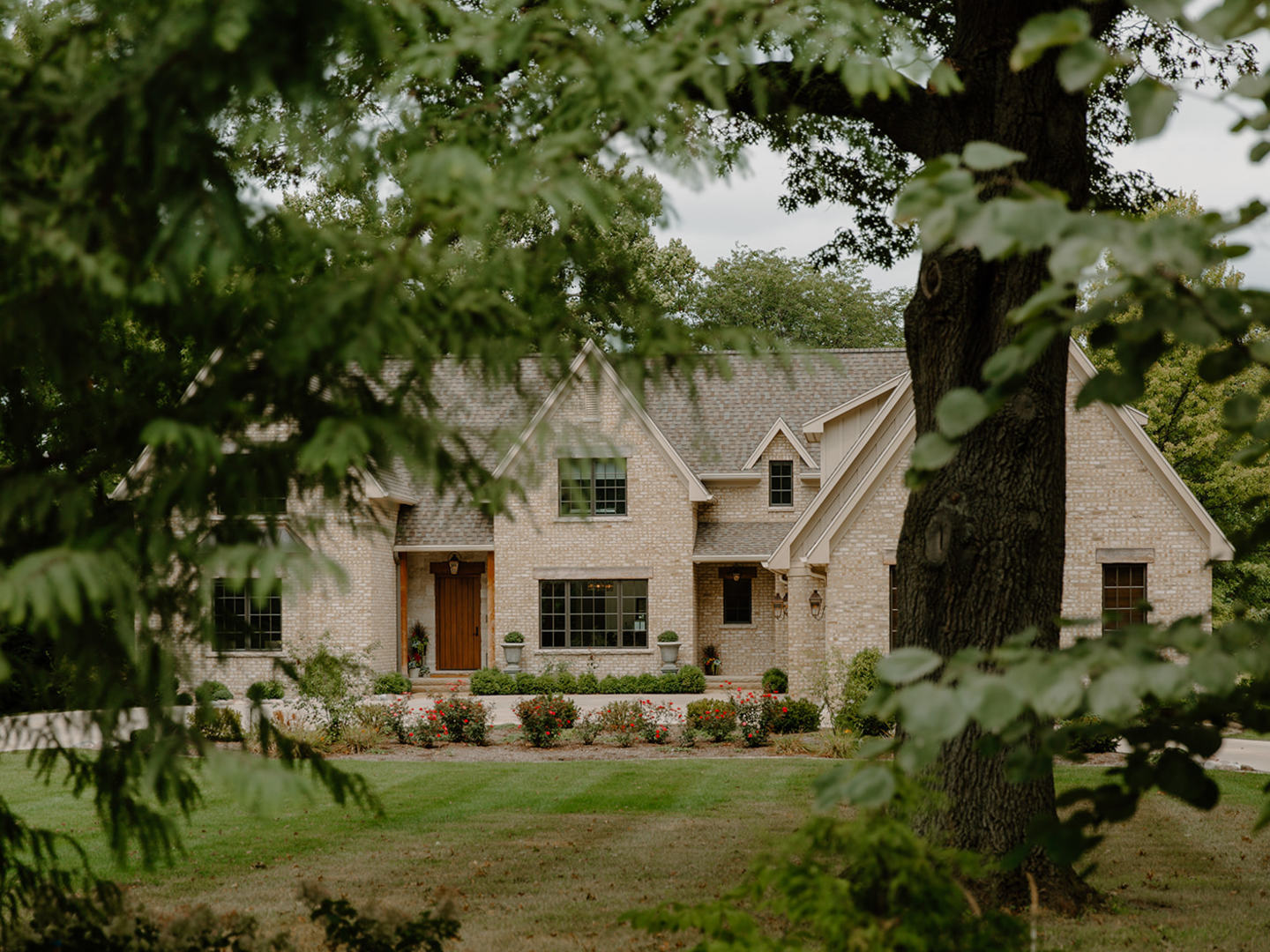 a front view of a house with a garden and plants