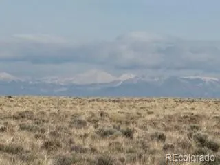 a view of water covered with snow in the background