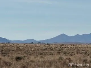 a view of a large mountain with a mountain in the background