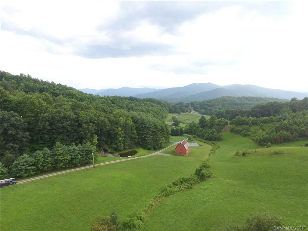 7-9 Gambrell Hill Road, Unit 79 Clyde, NC 28721 - Photo 1 of 24 a view of a green field with mountains in the background