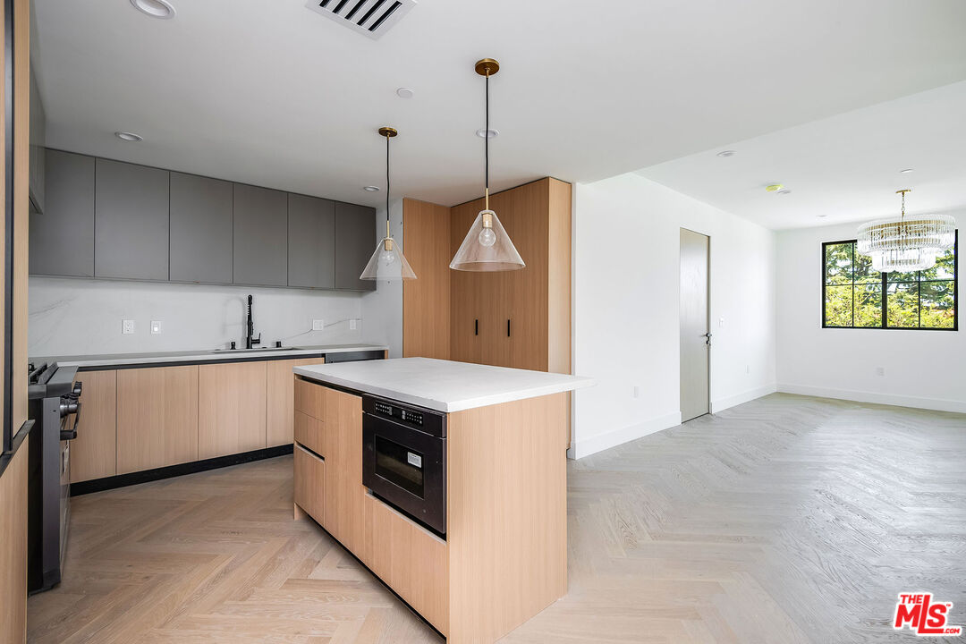10352 Riverside Drive, Unit 301 Toluca Lake, CA 91602 - Photo 4 of 19 a kitchen with a stove and a sink