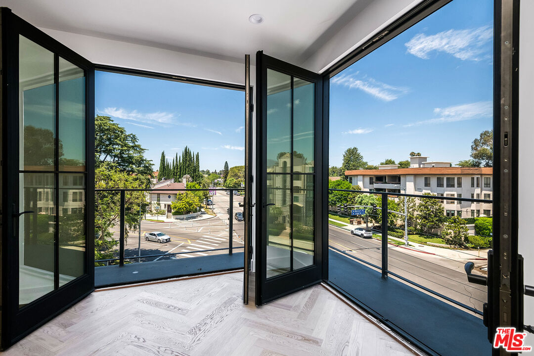 10352 Riverside Drive, Unit 301 Toluca Lake, CA 91602 - Photo 8 of 19 a view of a glass door and balcony