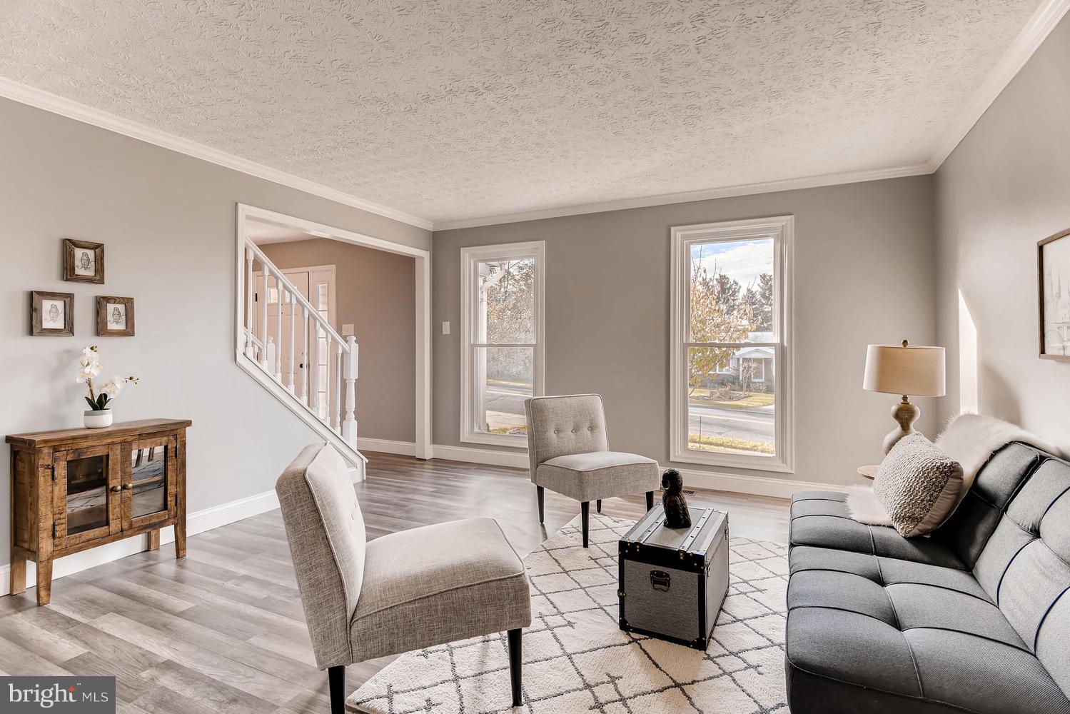Large living room with fresh paint, wood flooring