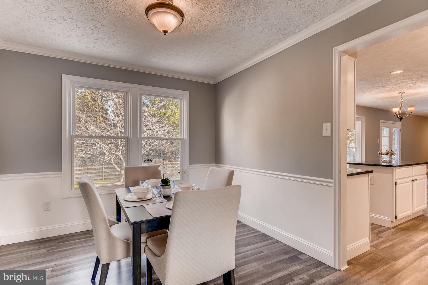 Separate dining area with chair rail/crown molding