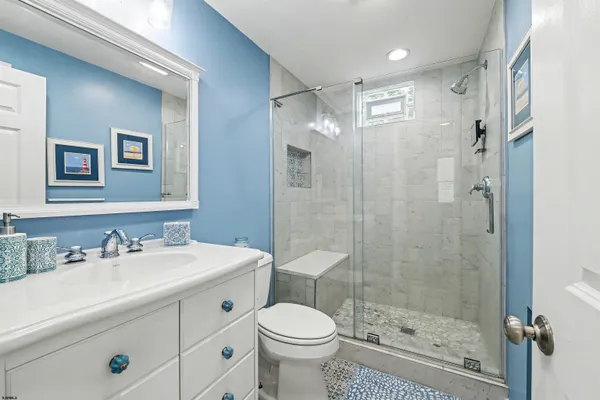 a bathroom with a sink toilet and shower