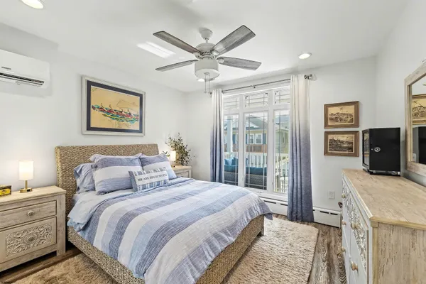 a bedroom with a large bed and a ceiling fan