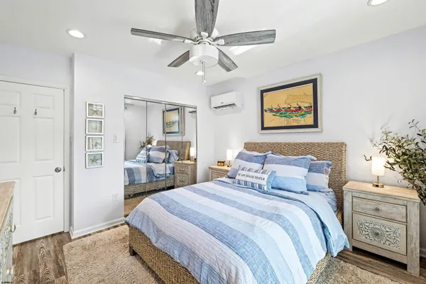 a bedroom with a bed and a painting on the wall