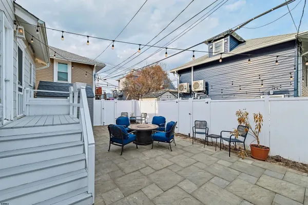 a view of a patio with table and chairs