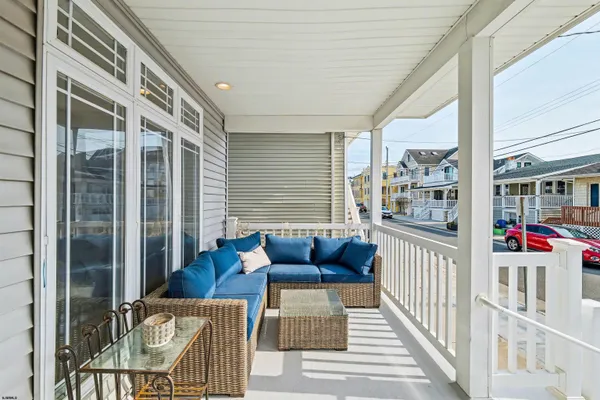 a balcony with furniture and next to a window