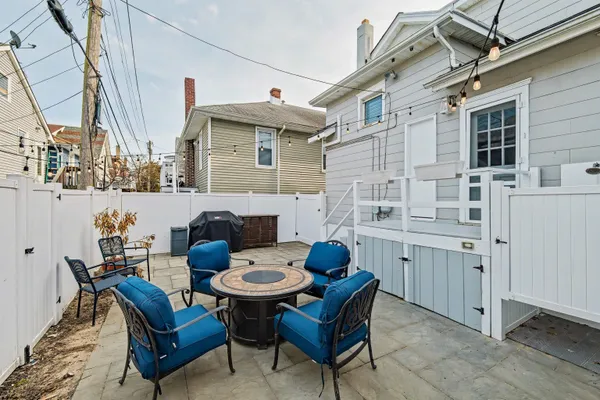 a view of a patio with table and chairs