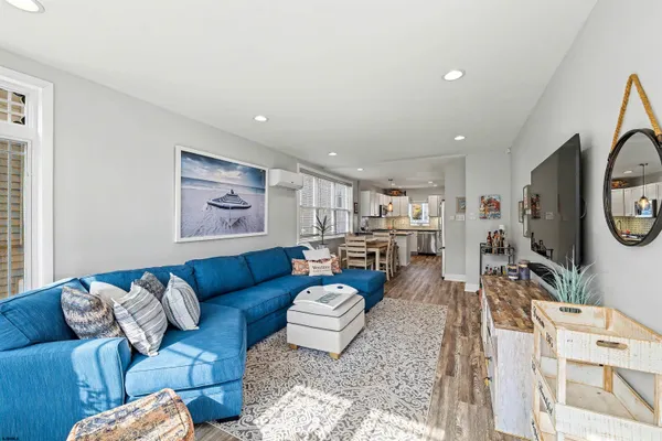 a living room with furniture a rug and a flat screen tv