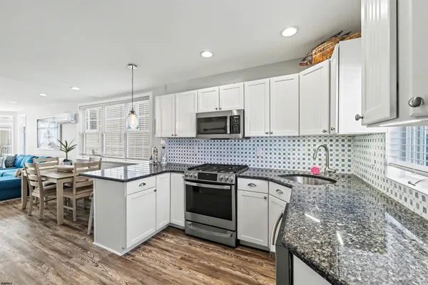 a kitchen with a sink stove and cabinets
