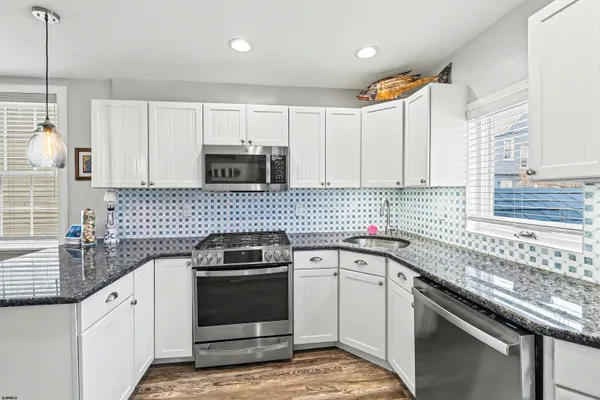 a kitchen with a sink stove and cabinets